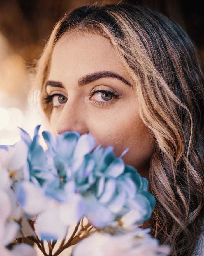 cta-02 Elegant woman with blue hydrangeas, capturing summer beauty.